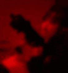 a woman is holding a gun and the word watcherz is on the red background