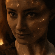 a close up of a woman 's face with lightning bolts coming out of it