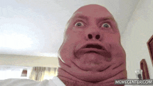 a close up of a man making a funny face with his mouth open .