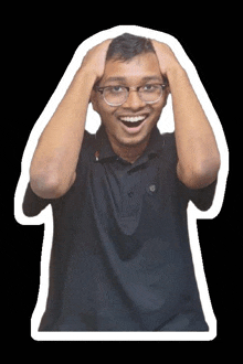 a young man wearing glasses and a black shirt is holding his head in his hands .