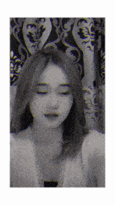 a woman taking a selfie in front of a curtain