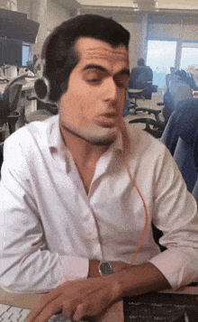 a man wearing headphones is sitting at a desk