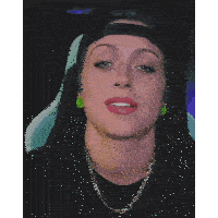 a woman with a nose ring is wearing a black hat and green earrings
