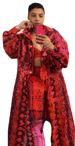 a woman in a red snakeskin coat takes a selfie