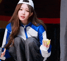 a girl wearing a blue and white jacket with the word gaku written on it