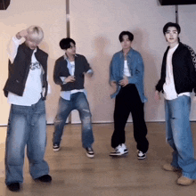 a group of young men are standing next to each other and dancing in a room .