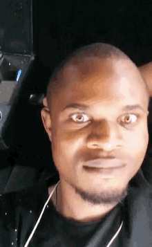 a close up of a man 's face with headphones on