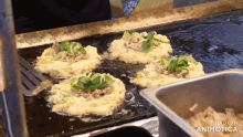 food being cooked on a grill with the words made in animotica visible
