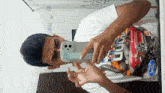 a man taking a picture of himself with a ford t-shirt on