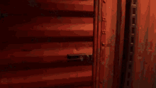 a close up of a red door with a handle on it .