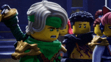 a group of lego figures are standing together and one of them is holding a sword