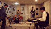 a man playing a keyboard in front of a drum set that says pearl