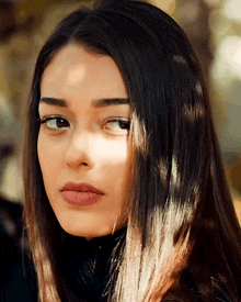 a close up of a woman 's face with her eyes closed