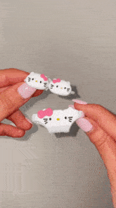 a person is holding a hello kitty airpod case