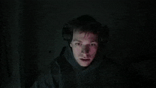 a blurry picture of a person using a computer in the dark .