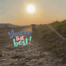 a sunset with the words you 're the best written on the ground