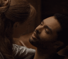 a man and a woman are looking at each other