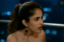 a close up of a woman 's face with her tongue hanging out