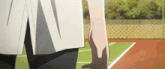 a person standing on a tennis court with their hand on their knee