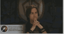 a man in a black shirt is sitting in front of a sign that says dungeon master