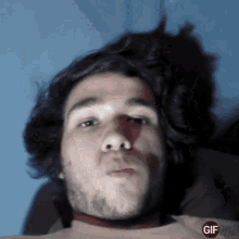 a close up of a man 's face with a gif on the bottom left