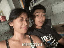 a man and a woman are sitting next to each other and the man is wearing a shirt that says 1980