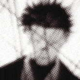 a black and white photo of a man 's face with white dots on it