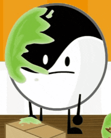 a black and white circle with a green leaf on it 's face .