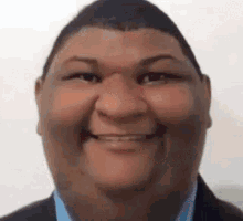 a close up of a man 's face with a smile on it .