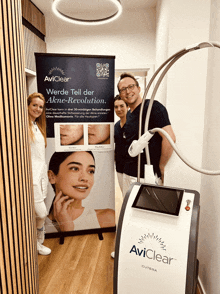 a group of people standing in front of an aviclear cutera machine