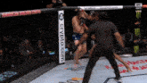 a fighter in a cage with a crypto.com banner