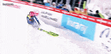 a person is skiing down a snowy slope with a sign that says ' lewanaria ' on the bottom