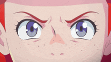 a close up of a girl 's face with red hair and blue eyes making an angry face