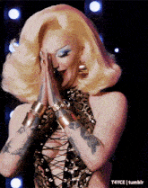 a woman with blonde hair is wearing a leopard print top and bracelets
