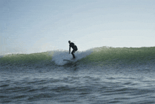 a man is riding a wave on a surfboard in the ocean