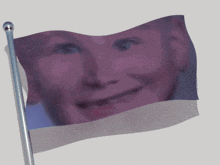 a flag with a picture of a child 's face waving in the wind