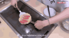 a person is cooking on a stove with a day off sticker on the bottom