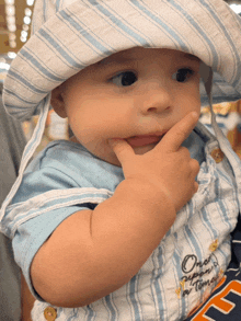 a baby wearing a hat and overalls with the words once upon a time embroidered on it