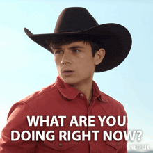 a man wearing a cowboy hat and a red shirt says what are you doing right now
