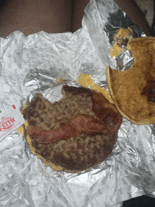 a keith sauce packet sits next to a burger