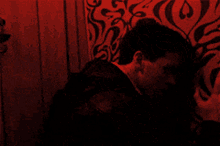a red and black background with a swirl pattern on it