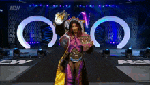 a woman in a wrestling outfit is holding a championship belt