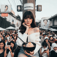 a woman holding a bowl of noodles in front of a sign that says museum bola