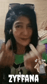 a woman wearing sunglasses and headphones with the name zyffana written on the bottom