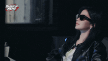 a woman wearing sunglasses with the name a-sa on the bottom right