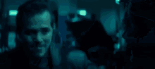 a group of men are standing next to each other in a dark room in a blurry photo .