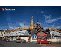 a poster for irrawaddy shows a red car in front of a temple