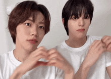two young men are making a heart shape with their hands and the words kn1 yes out are visible in the corner