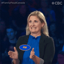 a woman with a name tag that says kim is clapping