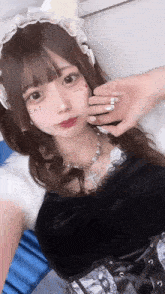 a girl in a maid costume has the word eat written on her face